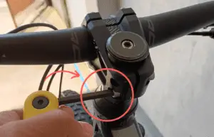 Unscrew the bolts connected to the handlebars.