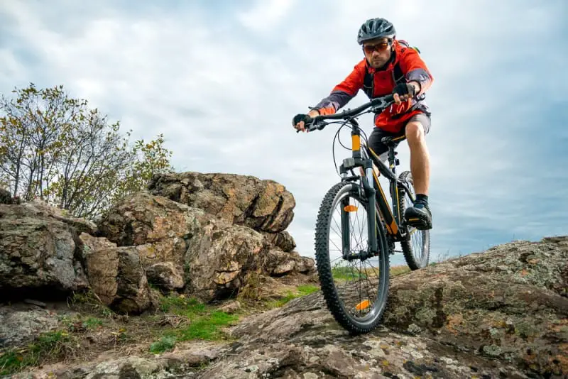 Cyclist Riding In A Rocky Terrain