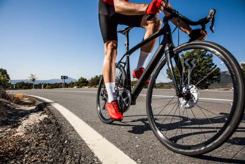 Man Riding Bicycle on a Road