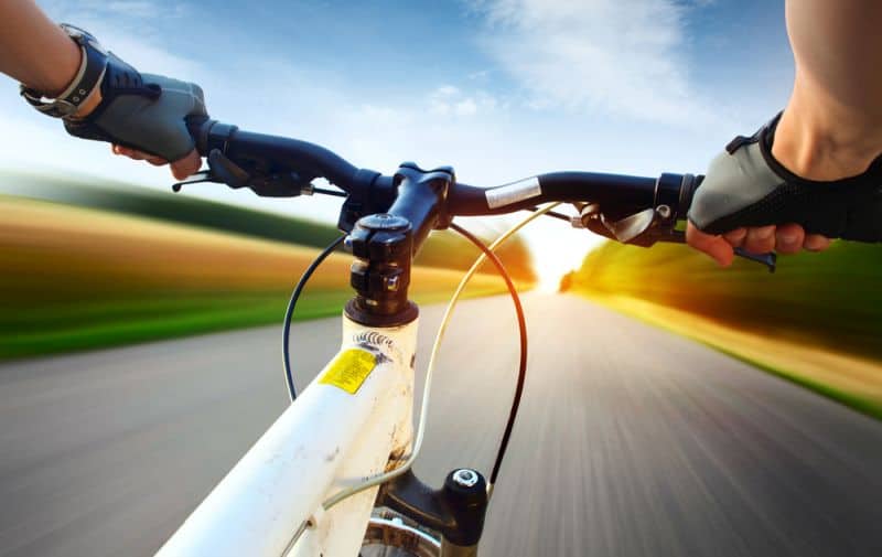 man riding mountain bike on road