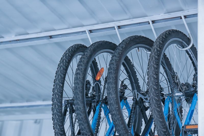 Bicycles hanging on rack under ceiling